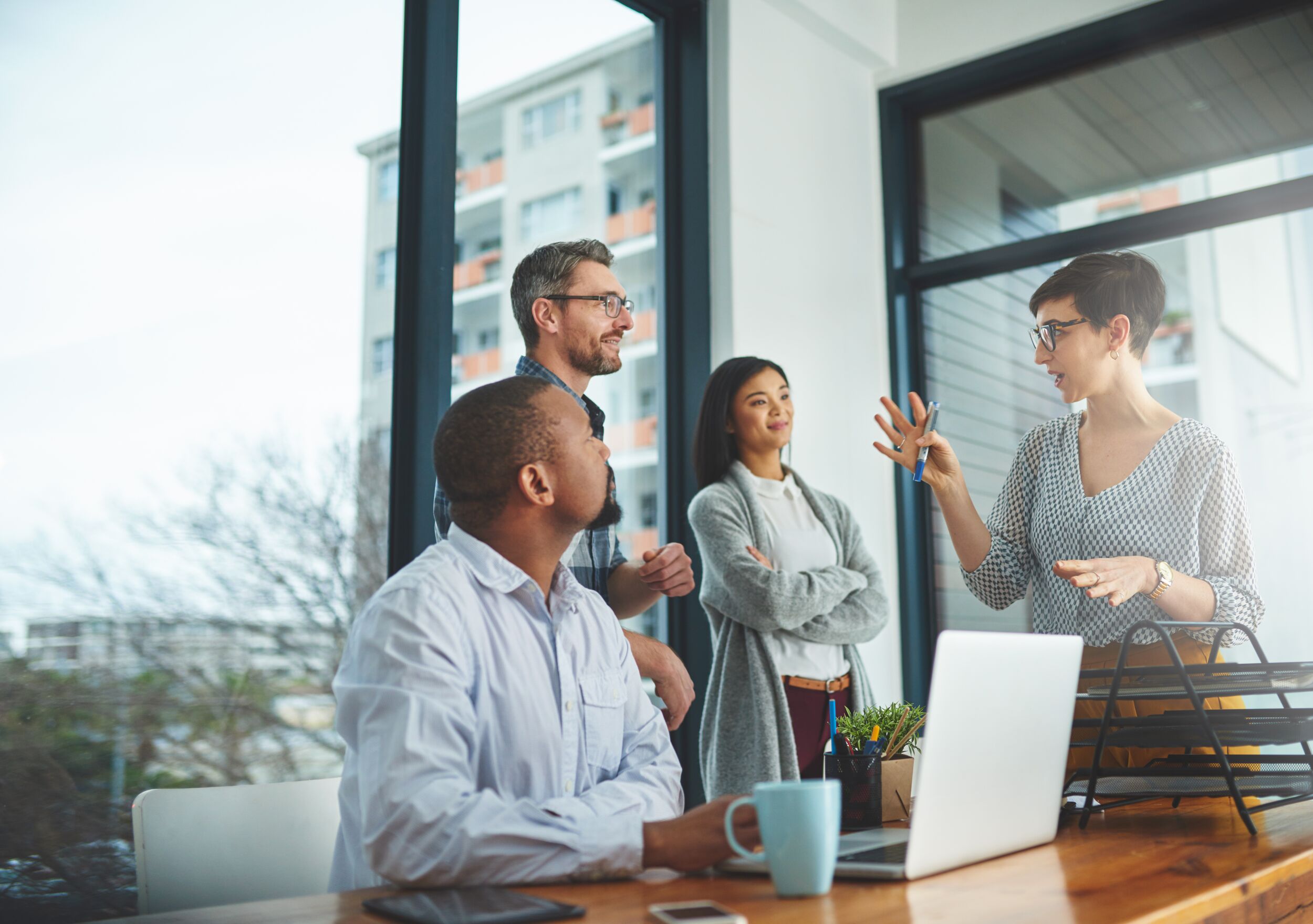 Woman leading coworker meeting.