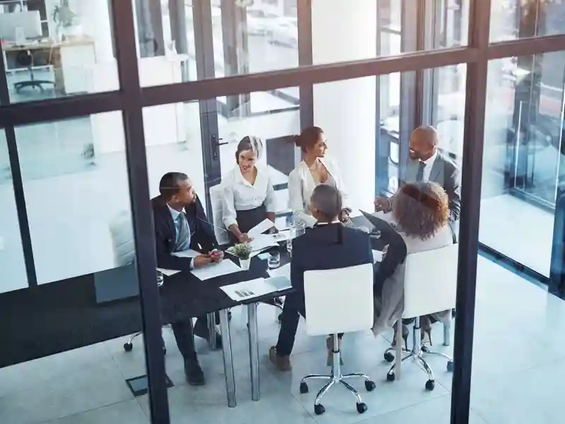 Business meeting in a glass conference room.