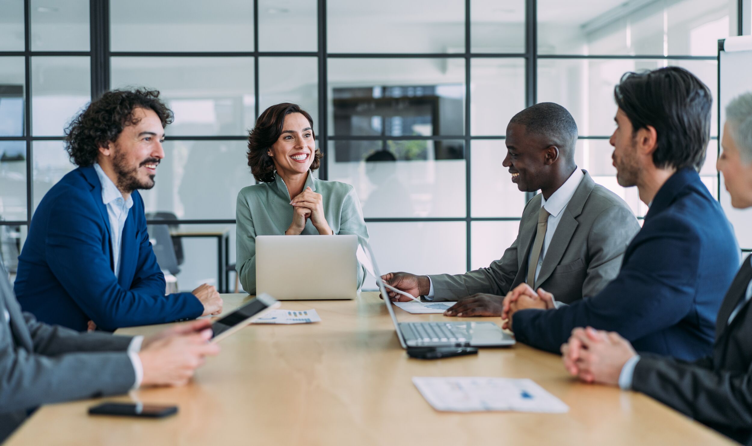 Coworkers meeting around a desk.