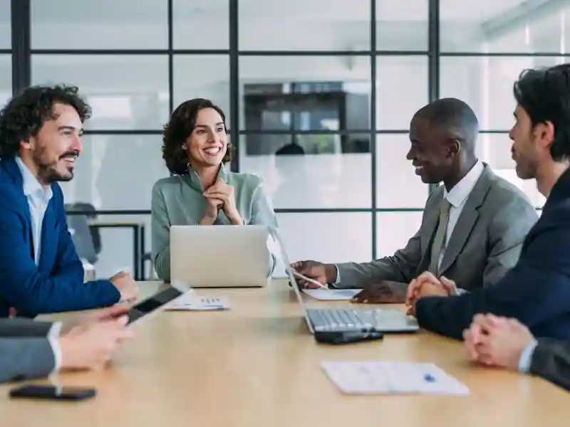 Coworkers meeting around a desk.