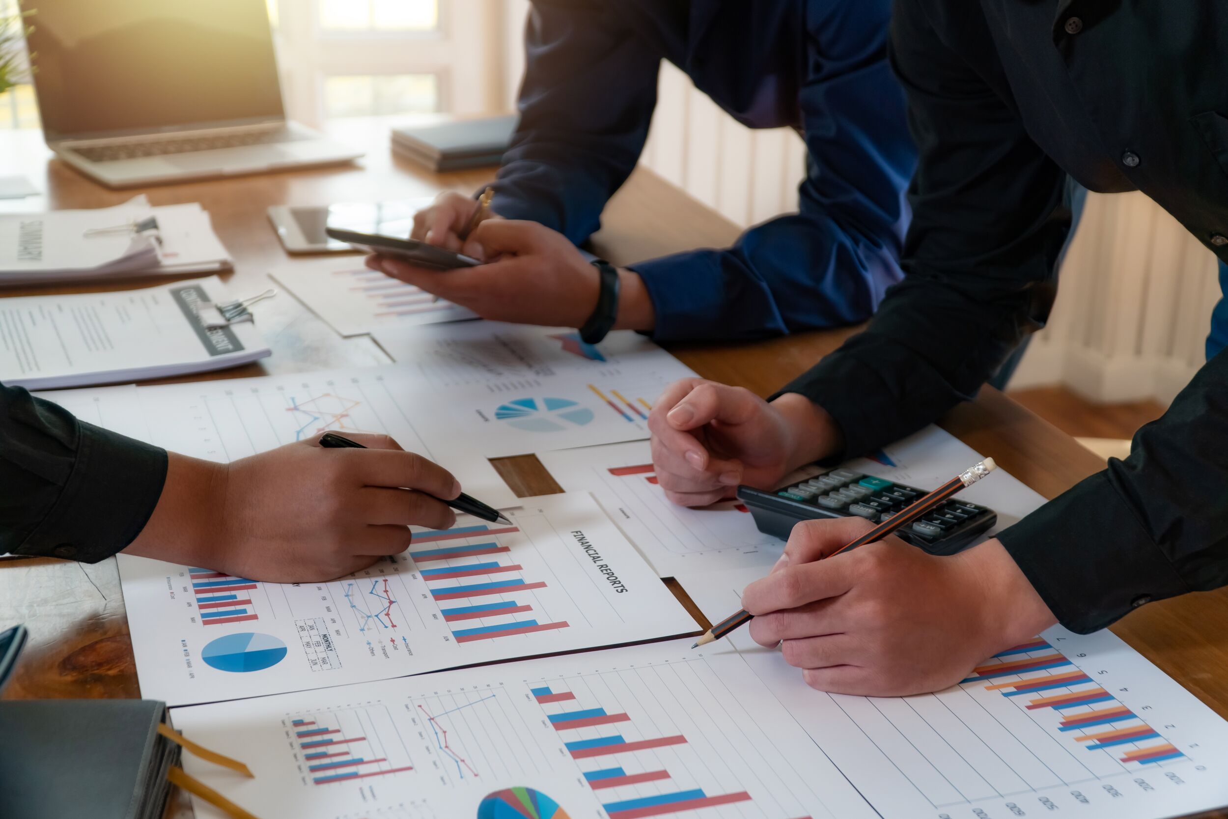 Cowrkers reviewing stock charts.