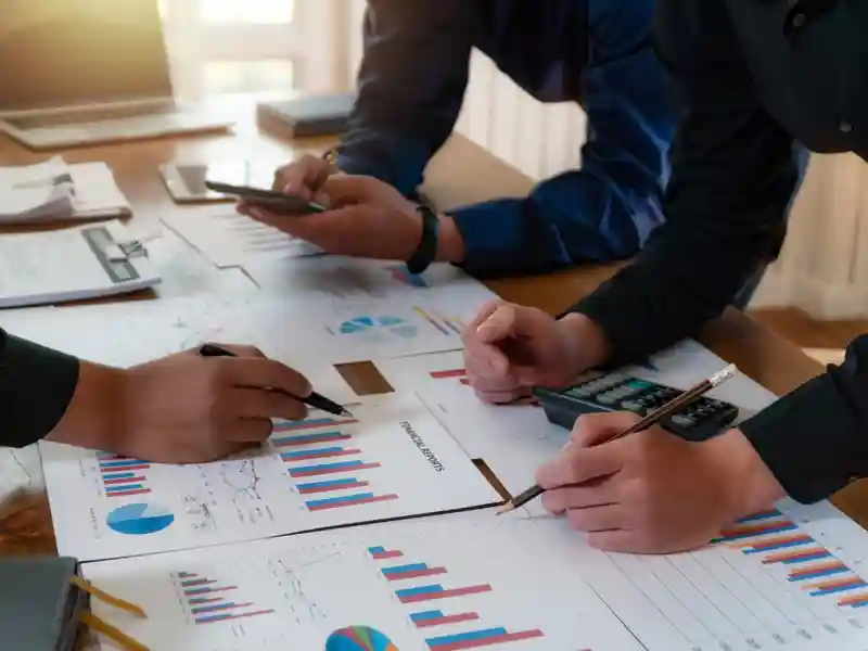 Cowrkers reviewing stock charts.