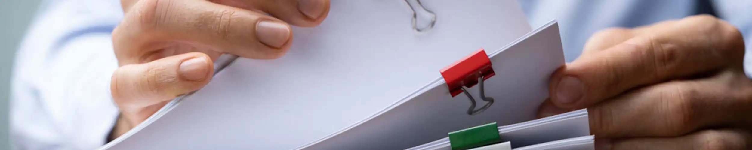 man reading through papers