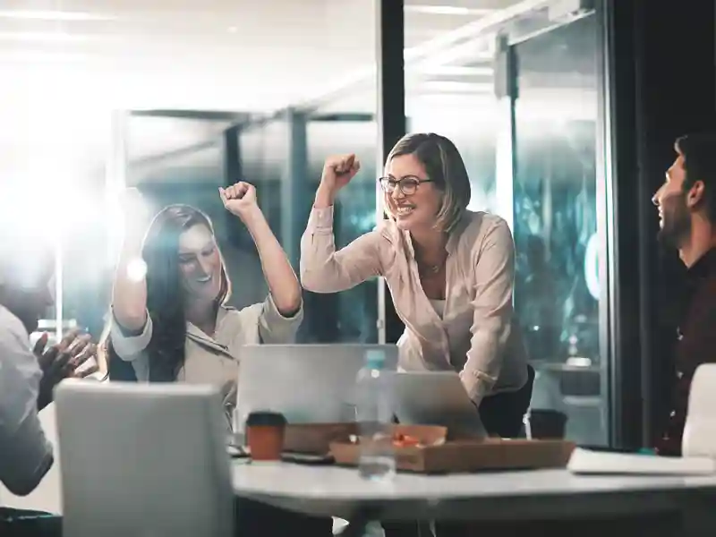 Female coworkers celebrating.